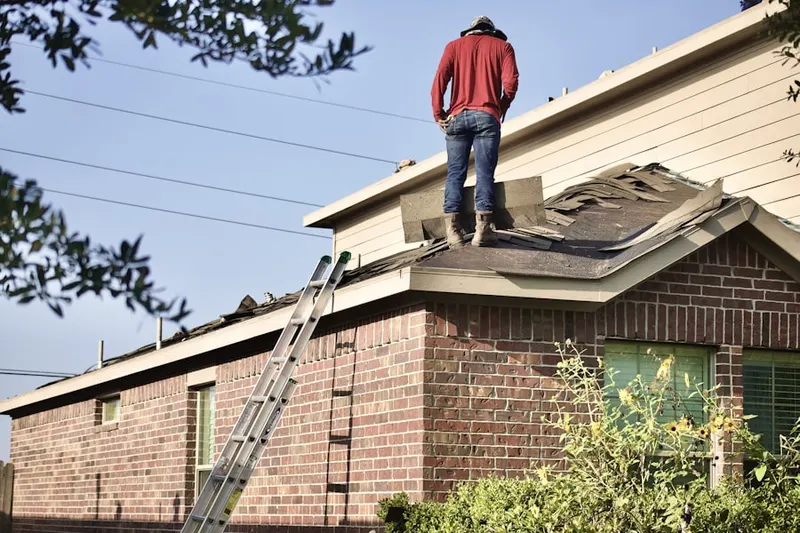 Professional roofer working on a residential roof in Hunters Greene
